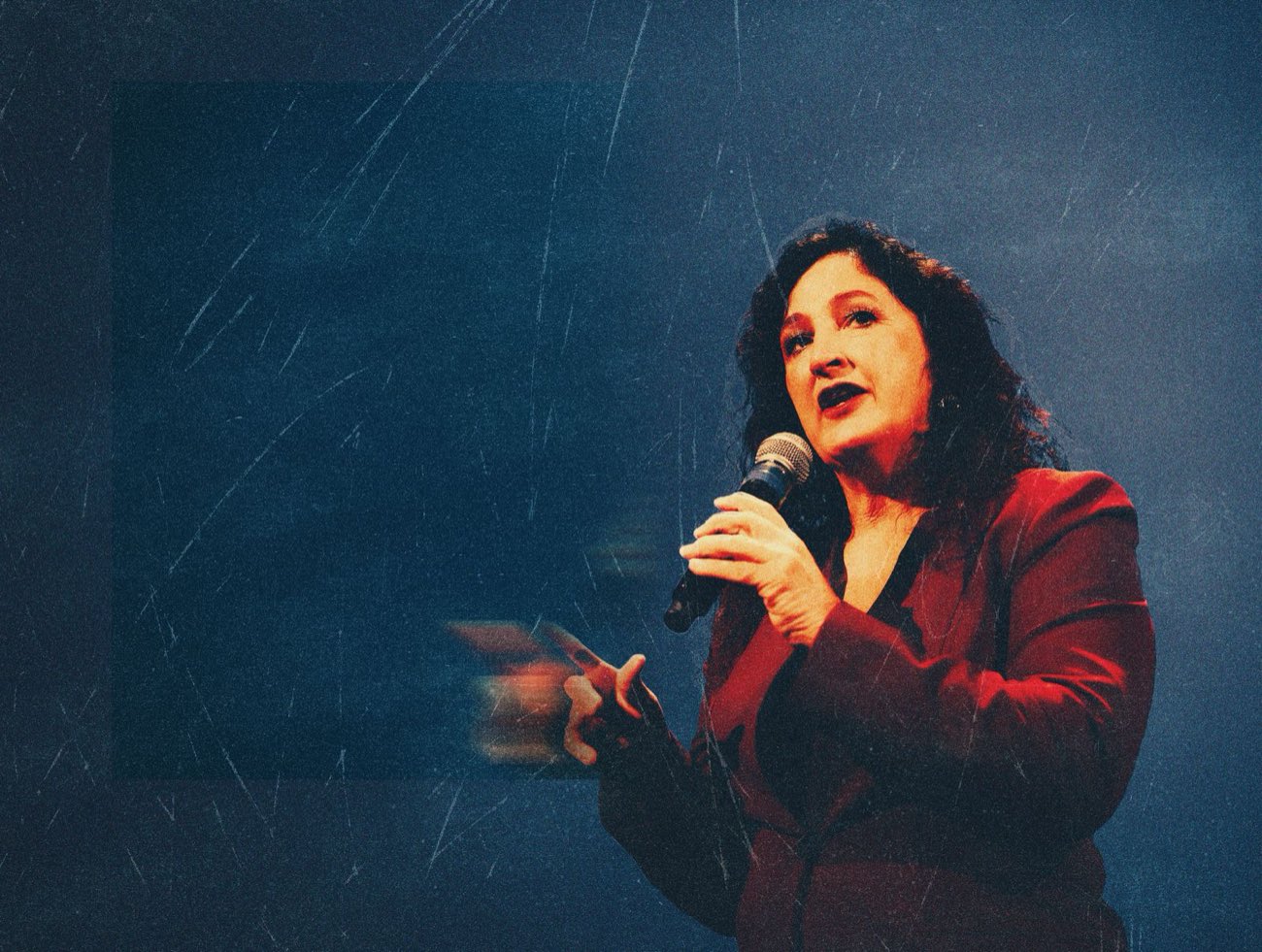 Kathryn Kellner speaking with a microphone on stage